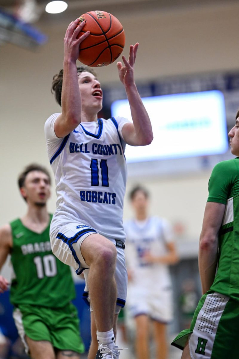 Bell County junior guard Jaxon Thomas sailed to the basket for two of his 18 points Tuesday in the Bobcats’ 82-42 win over visiting Harlan.