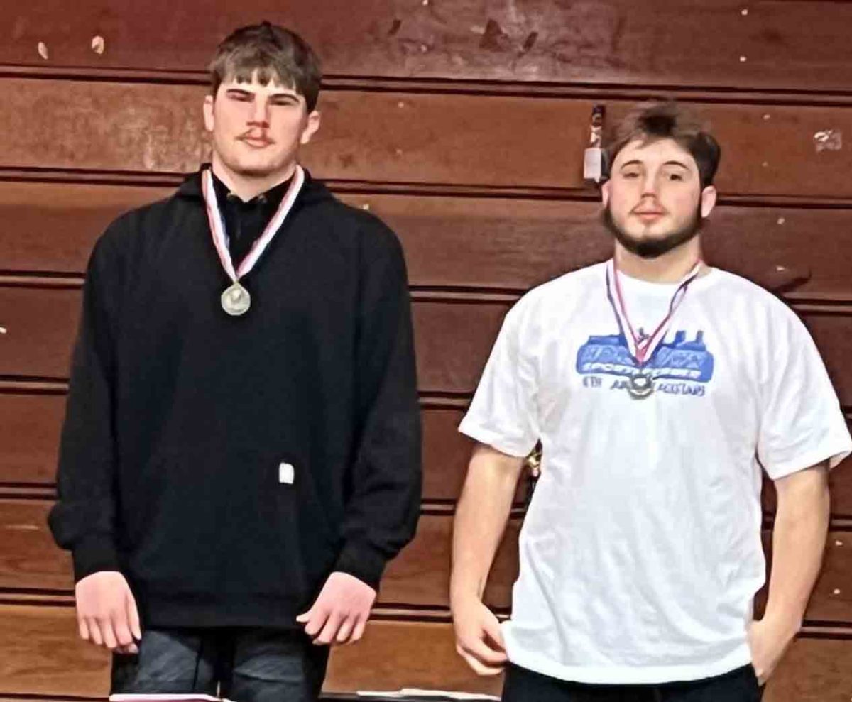 Harlan County’s Bo Eldridge (left) and Dylan Clem each won their weight class in the Appalachian Duels meet last week at Knott Central High School.