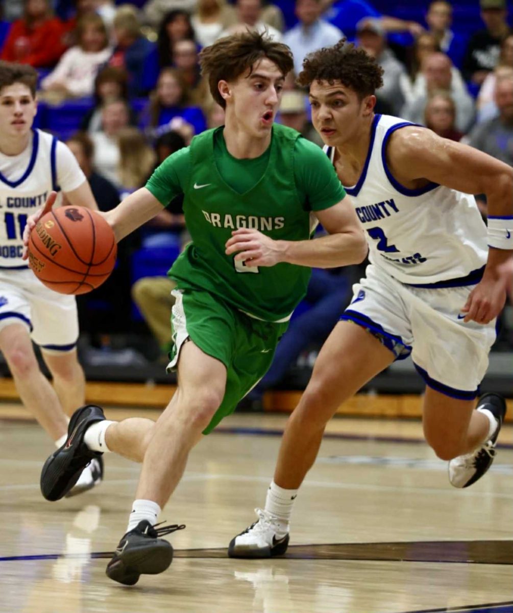 Harlan guard Jaxson Perry drove around a Bell County defender in Tuesday's district clash.