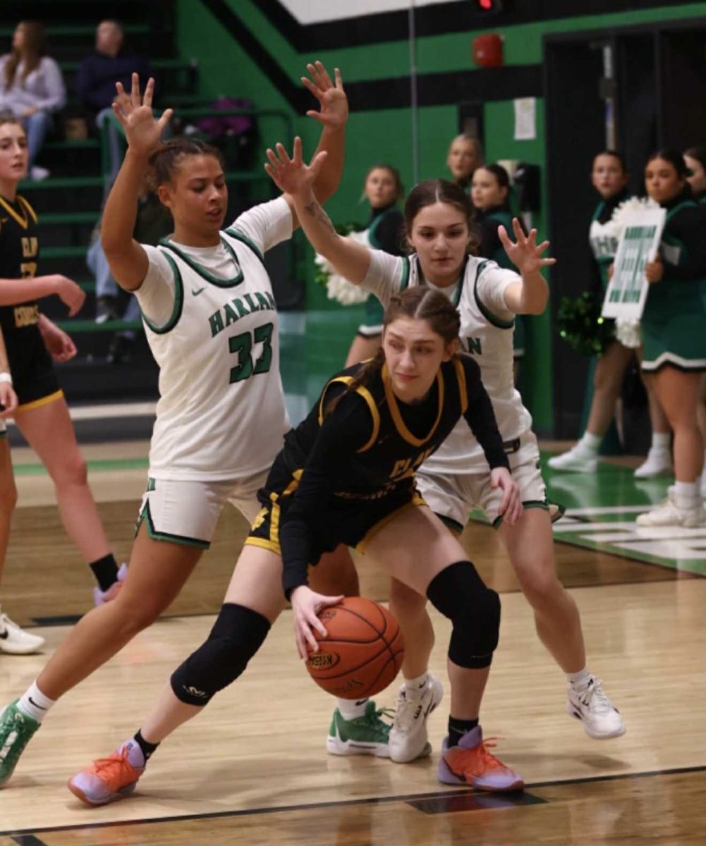 Harlan’s Raegan Goodman and Shelby Doan surrounded Clay County’s Madison Pendland in Tuesday’s 13th Region clash. The Lady Tigers posted a 73-55 victory.