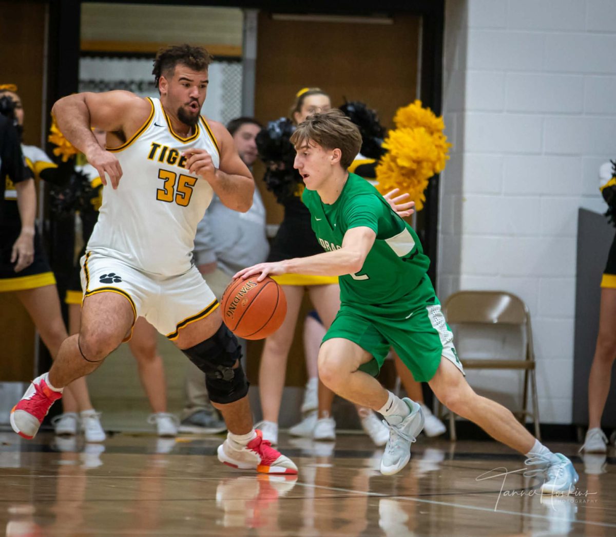 Harlan guard Jaxson Perry worked to the basket against Clay County center Aiden Wagers in Thursday's game in Manchester. Clay rolled to an 87-49 victory.
