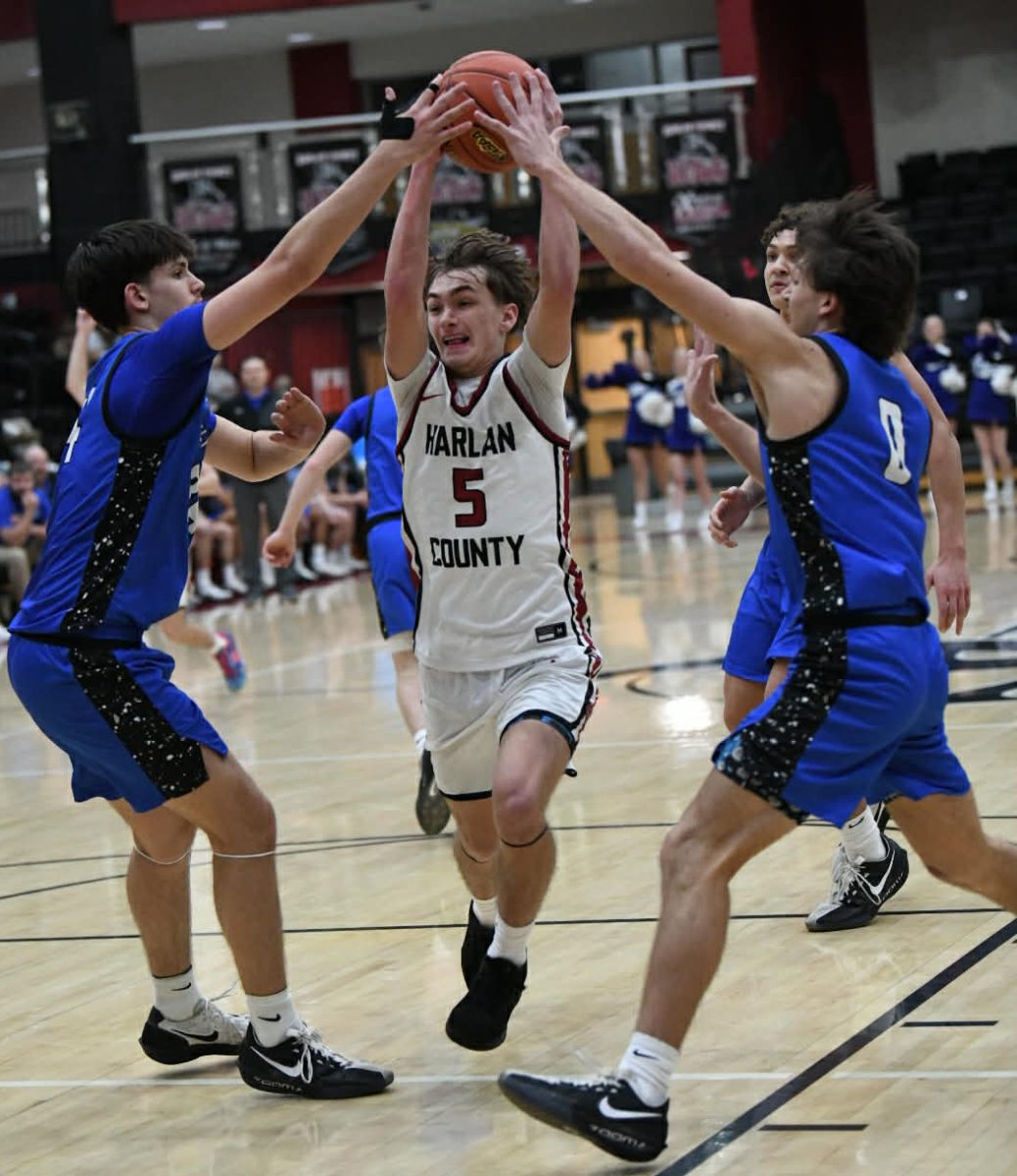 Harlan County senior forward Brennan Blevins sliced between Bell County's Ethan Buell and Cayden Huff in Wednesday's game. The Bobcats improved to 4-0 in district action with a 78-40 win.