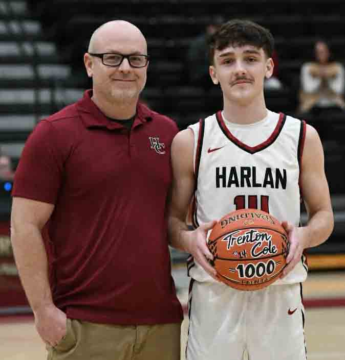 Harlan County junior guard Trent Cole was recently honored for scoring his 1,000th point in high school earlier this season. Cole is pictured with HCHS coach Kyle Jones.