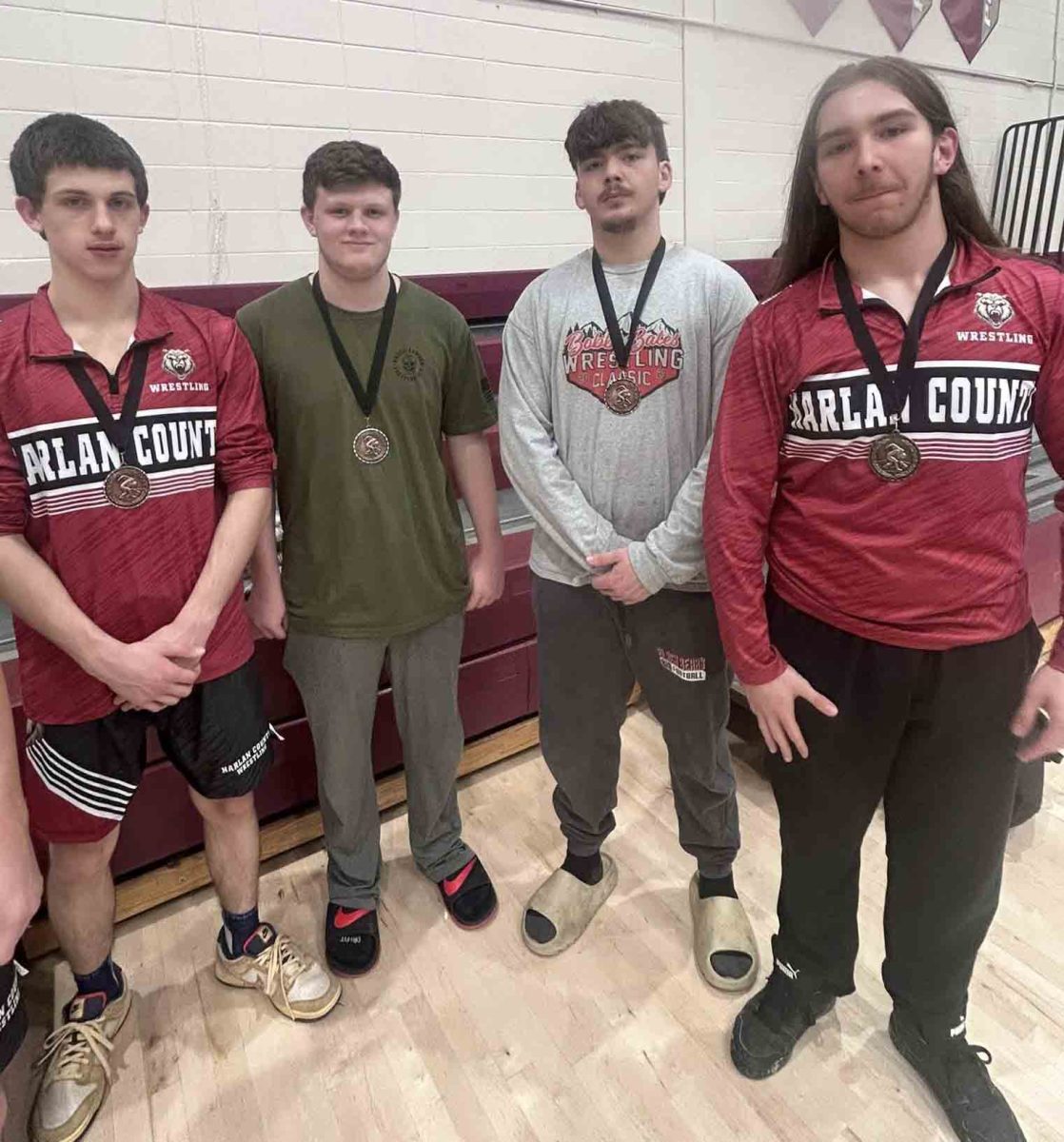 The Harlan County High School wrestling team placed eighth out of 15 teams in a meet at Pulaski County. The HCHS wrestlers who placed included, from left, Cameron Fortune (fourth place in the 138-pound division), Dylan Clem (third place in 175-pound division), Blake Short (fourth place in the 215-pound division) and Hayden Peterson (first place in the 190-pound division).