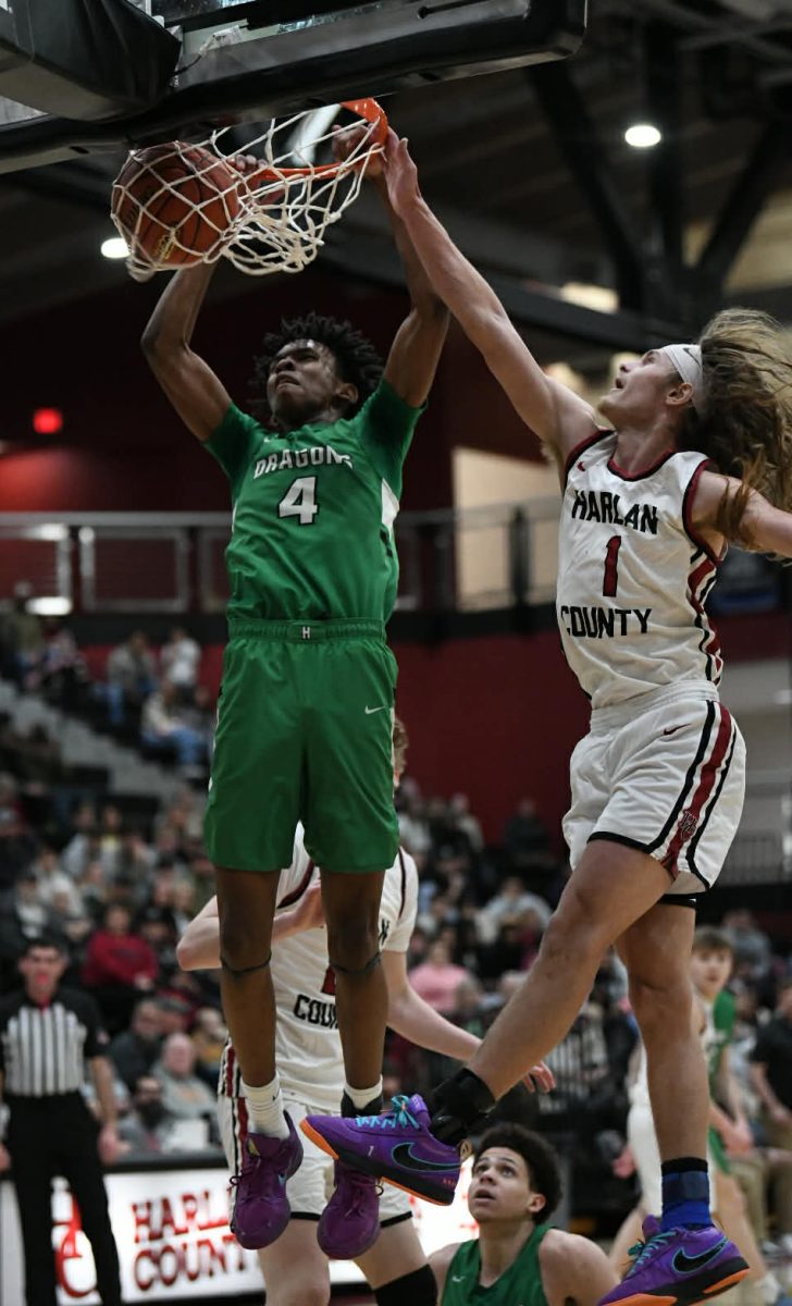 Harlan junior forward Legend Mimes slammed home two points off a rebound during a district game Friday at Harlan County. Mimes led the Dragons with 23 points in a 69-50 loss.
