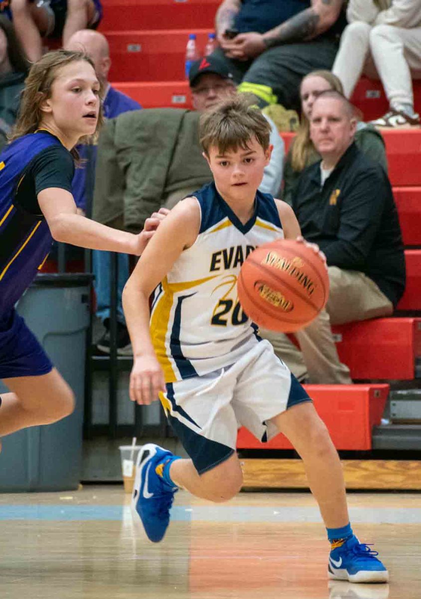 Evarts guard Brady White drove around Wallins' Sam Carmical in county tournament action Thursday. 