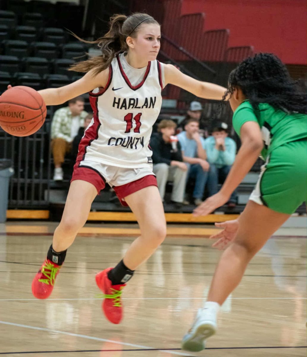 Harlan County guard Reagan Clem worked around a Harlan defender In Friday’s district clash. Clem scored 10 points as the Lady Bears won 69-44.