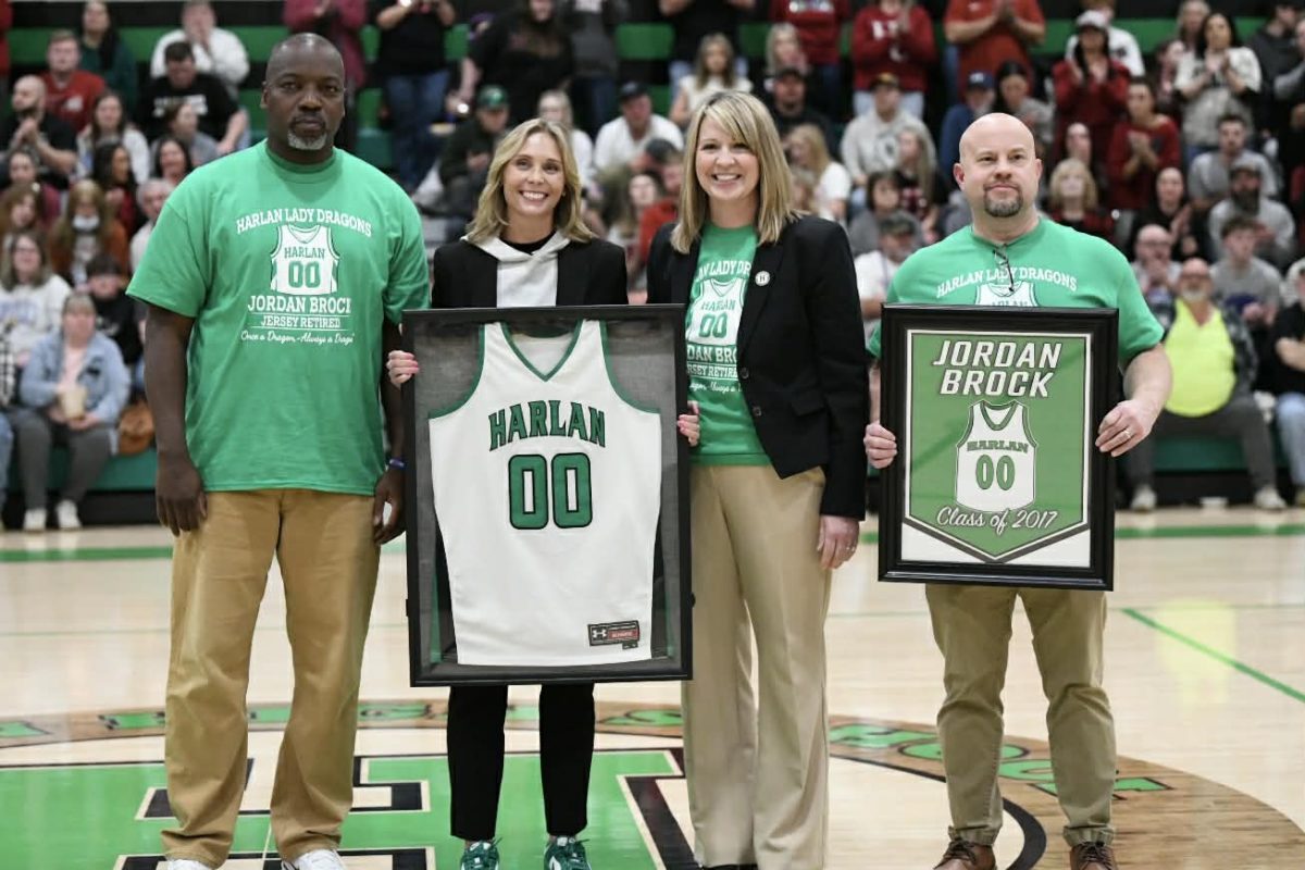 Former Harlan all-stater Jordan Brock was honored Friday between games of the Harlan County-Harlan doubleheader. Brock is pictured with her former coach, Derrick Akal, along with Harlan Independent Schools Superintendent Jennifer Parsons and Harlan High School Principal Mike Bolton.