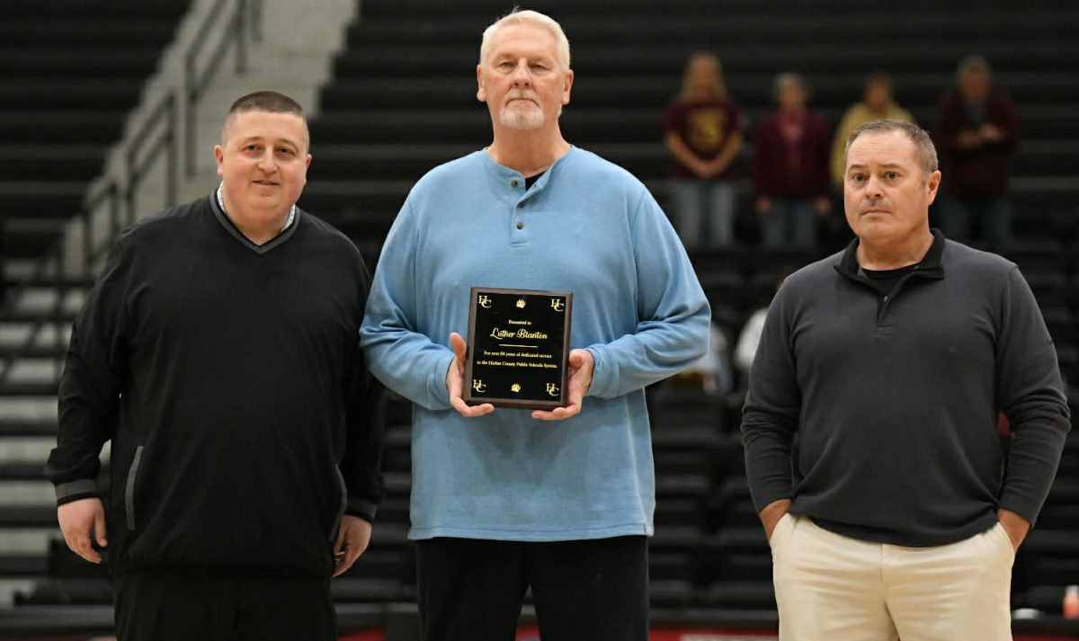 Photo by Chrissie Brassfield
Former Harlan County High School basketball scorekeeper Luther Blanton was honored Thursday before the Black Bears’ game against Pineville. Those participating in the ceremony included Harlan County High School athletic director Eugene Farmer and former Cawood coaches Greg Coldiron and Anthony Nolan. Blanton was unable to attend as he receives treatment in Lexington for liver cancer.