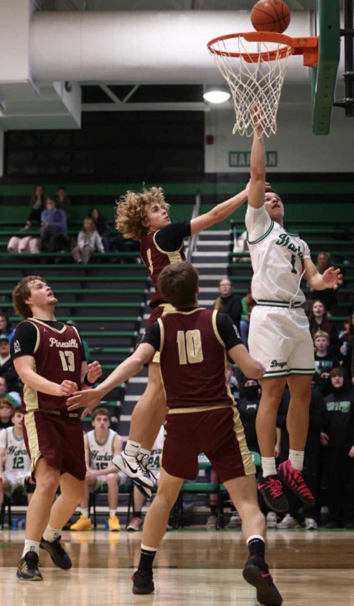 Harlan sophomore forward Braxton Rowe went inside for a shot during the Green Dragons' 84-61 win Friday over Pineville.