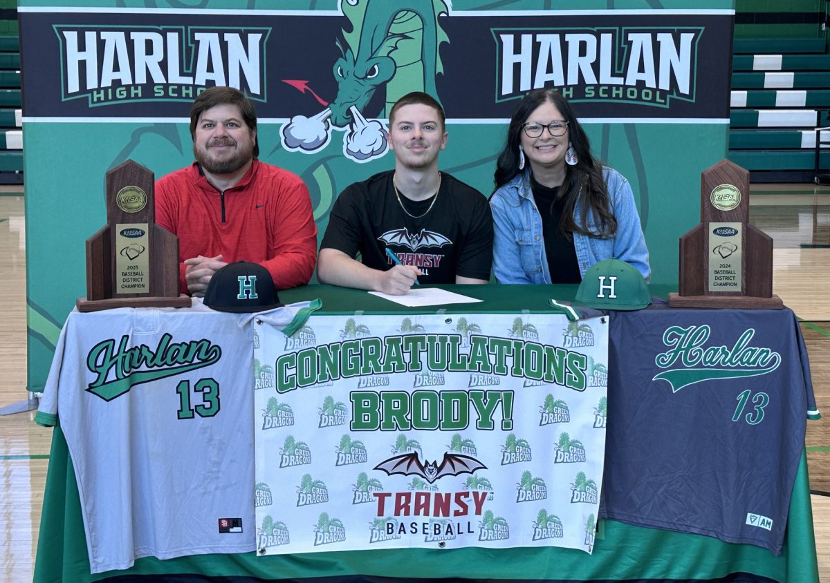 Harlan senior Brody Owens signed with Transylvania University on Monday to continue his baseball career. He is pictured with his parents, Chuck and Josephine.