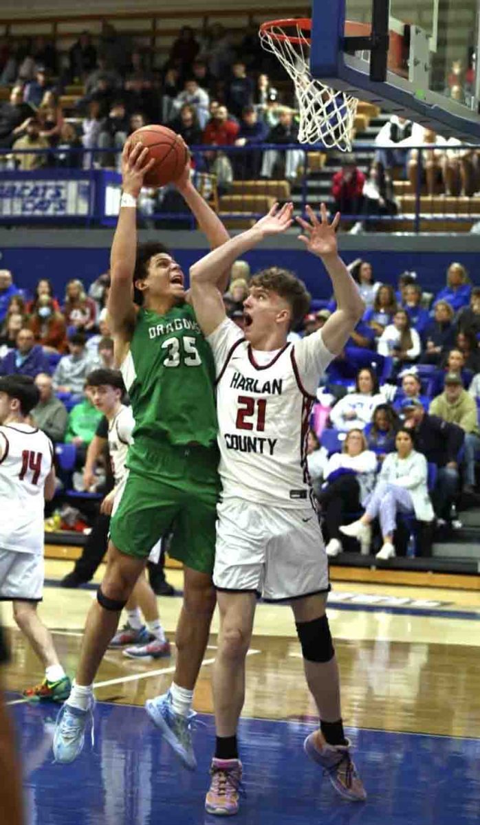Harlan center Kobe Noe worked inside for a shot against Harlan County's Tucker Curtis in 52nd District Tournament action Tuesday.
