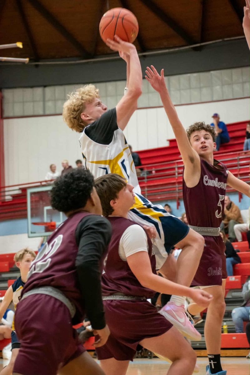 Evarts guard Caysen Farley was surrounded by Redskins as he went up for a shot Monday in action from the county seventh- and eighth-grade tournament. Evarts advanced to the semifinals with a win.