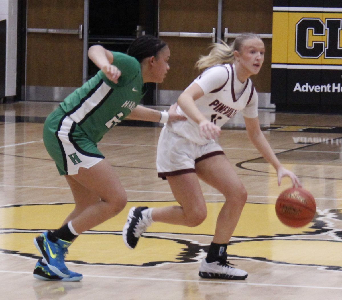 Pineville guard Clara Strange brought the ball down court againts Harlan's Peyshaunce Wynn in action Saturday from the Donnie Gray Shootout at Clay County. Strange scored 12 points in the Lady Lions' 69-35 victory.
