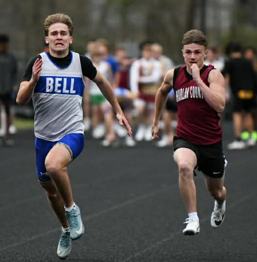 Bell County's Nathaniel Saylor and Harlan County's Jonah Sharp battled during the 100-meter dash Friday at HCHS.