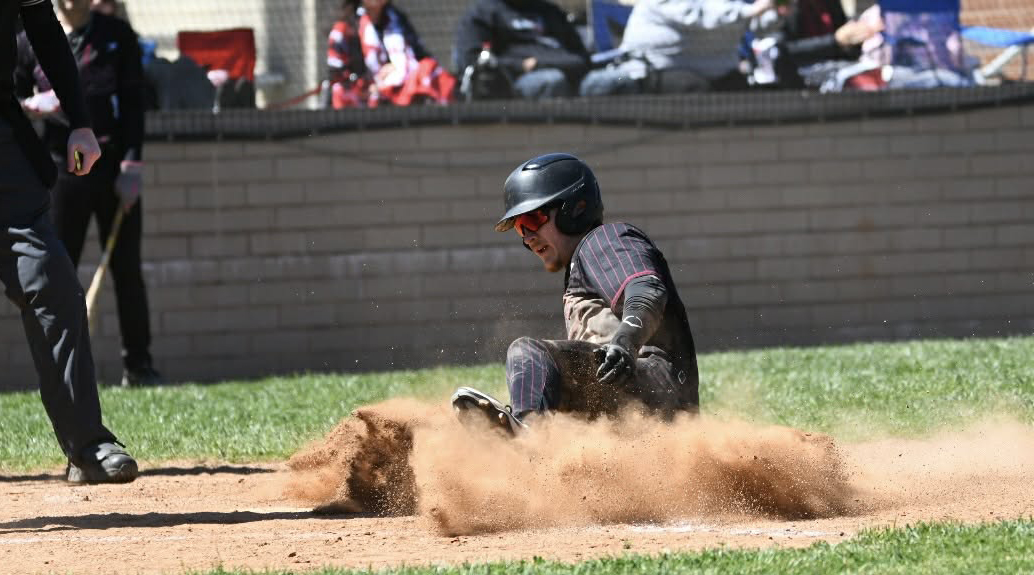 Harlan County third baseman Gunner Burkhart slid home with a run in the Black Bears' 15-0 win Saturday over visiting Thomas Walker, Va.