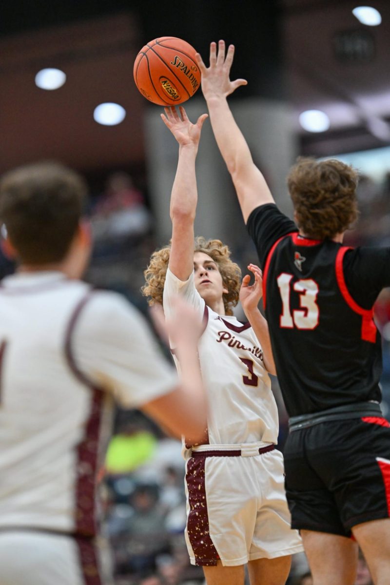 Pineville guard Anderson Gentry put up a shot over Whitley County's Garrett Sharp in 13th Region Tournament action Wednesday. Sharp led the Colonels with 18 points in a 76-48 victory.