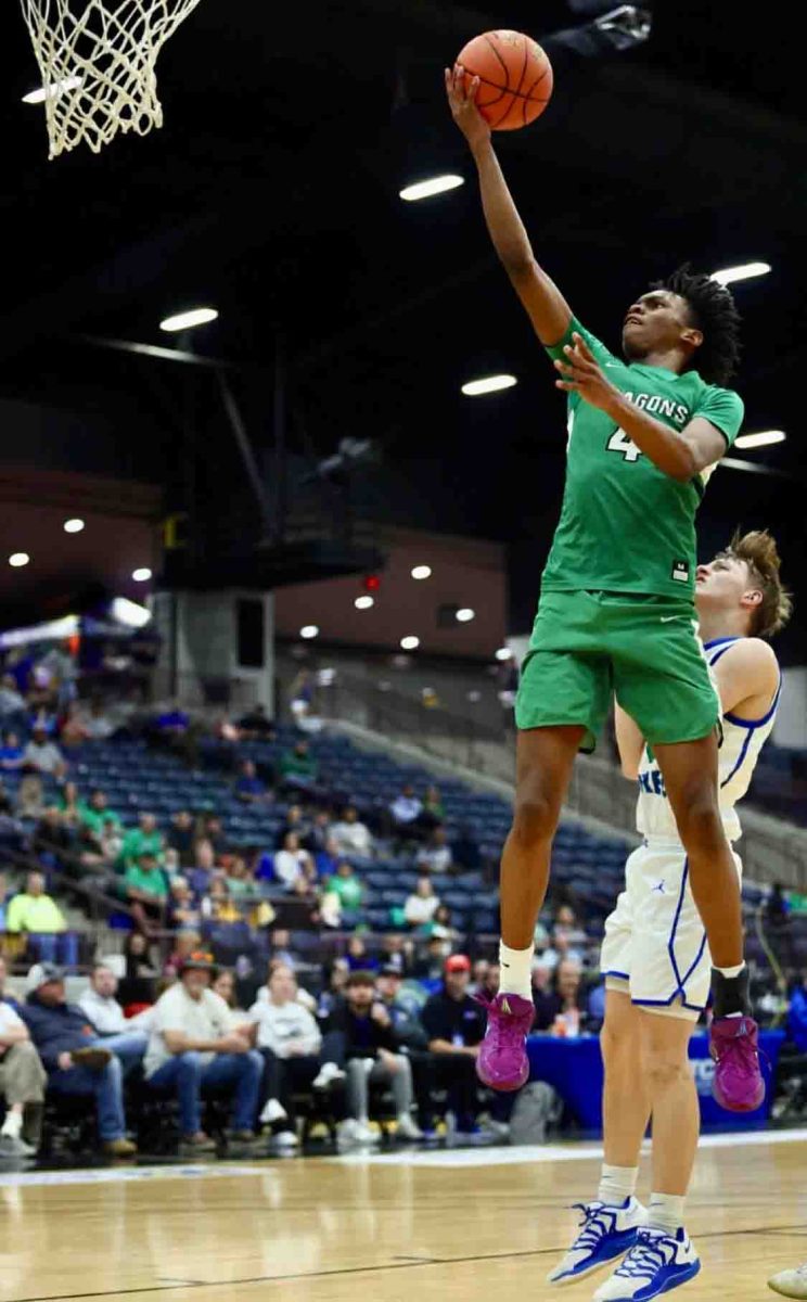 Harlan junior forward Legend Mimes sailed in for one of his three baskets in the second quarter against North Laurel in the 13th Region Tournament. The Dragons pulled even against the heavily favored Jaguars in the third quarter before falling 49-36.
