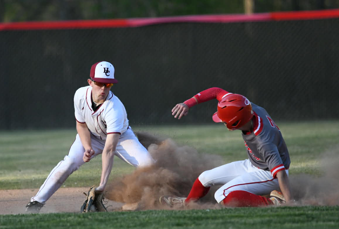 A Corbin runner slid into second base Thursday as Harlan County second baseman Jesse Gilbert took the throw in Thursday’s game. The Redhounds rolled to a 17-2 win in four innings.

