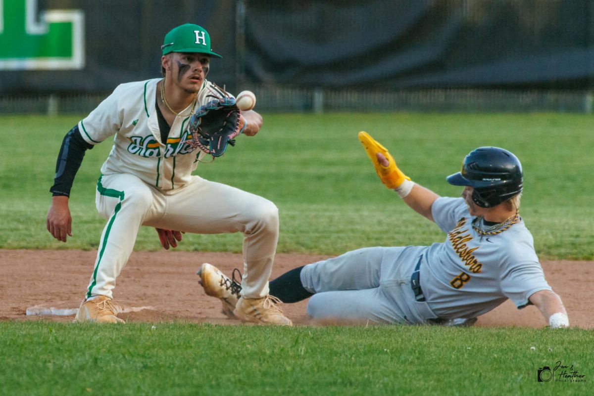 Harlan shortstop Baylor Varner took a throw as Middlesboro's Mitchell Capps slid into second base during Friday’s district game. Varner earned the win on the mound as the Dragons scored a run in the seventh inning to win 6-5.

