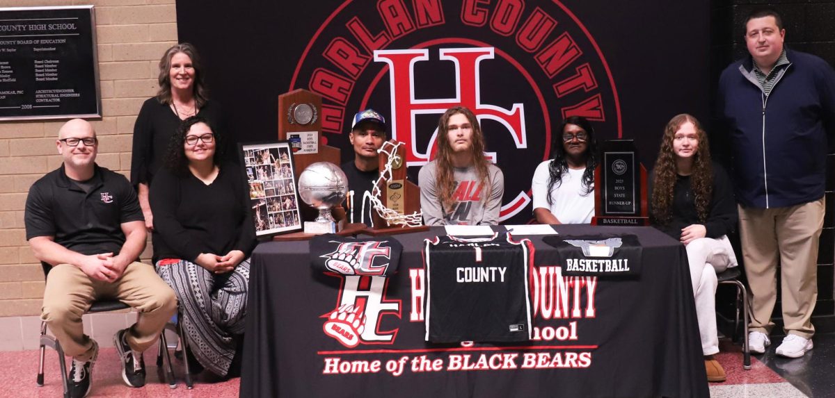 Harlan County senior Reggie Cottrell signed Thursday with Union Commonwealth University. Pictured with Cottrell at the signing ceremony, from left, are Harlan County coach Kyle Jones, HCHS Principal Kathy Napier, Reggie Cottrell Sr., Cottrell, Teresa Napier, Chelsea Cottrell and HCHS athletic director Eugene Farmer.