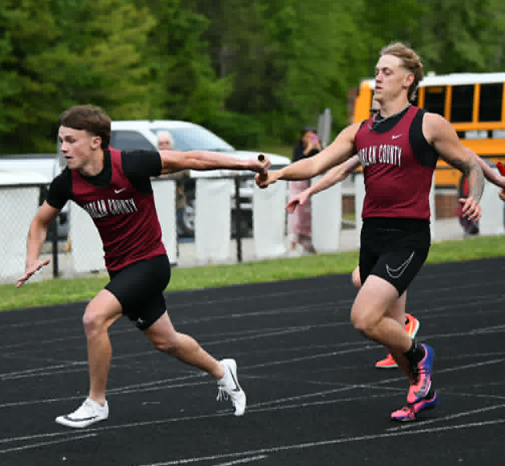 Harlan County's Ryan Day handed the baton to Jonah Sharp during a relay event Friday in the Area 9 Championship.