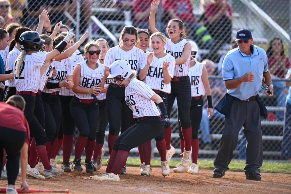 Harlan County freshman shortstop Jordyn Smith was greeted at home plate after her home run Monday in the Lady Bears’ 12-0 win over Harlan in the 52nd District Tournament at Middlesboro.