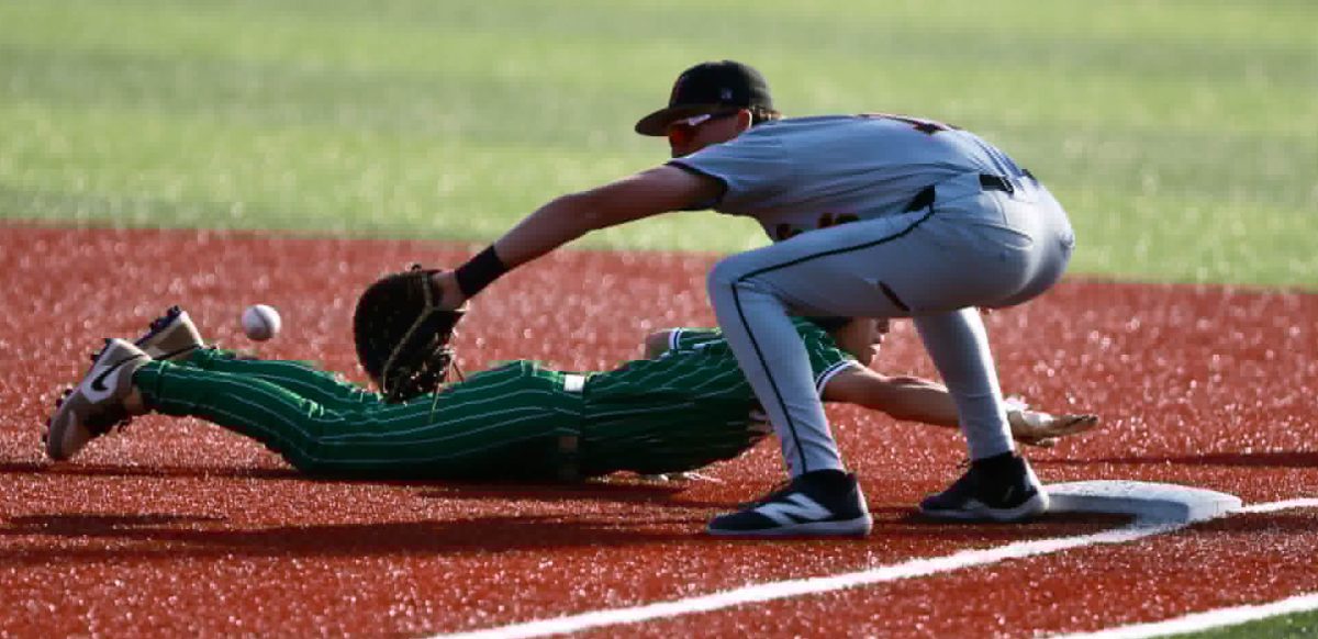 Harlan’s Jake Brewer dived back to first base in acton from the 13th Region Tournament on Wednesday. The Green Dragons fell 7-3 to end their season at 18-14.
