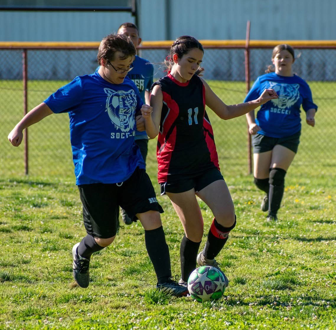 Black Mountain’s Hunter Roark and James A. Cawood’s Hailey Collins battled for the ball Tuesday in action from the county soccer tournament.