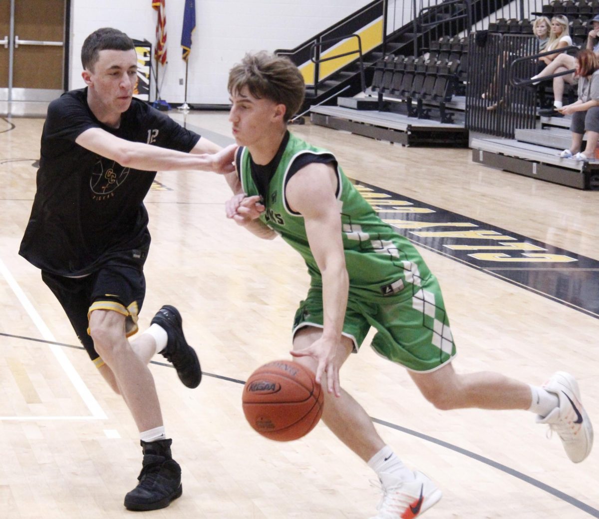 Harlan junior guard Jaxson Perry drove against a Clay County defender in scrimmage action earlier this week. The Dragons fell to Henry Clay and Corbin in scrimmages Friday at Georgetown College.