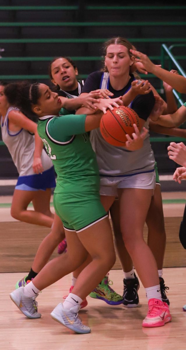 Harlan's Addison Sanford looks for a teammate in scrimmage action Monday against visiting Letcher Central.